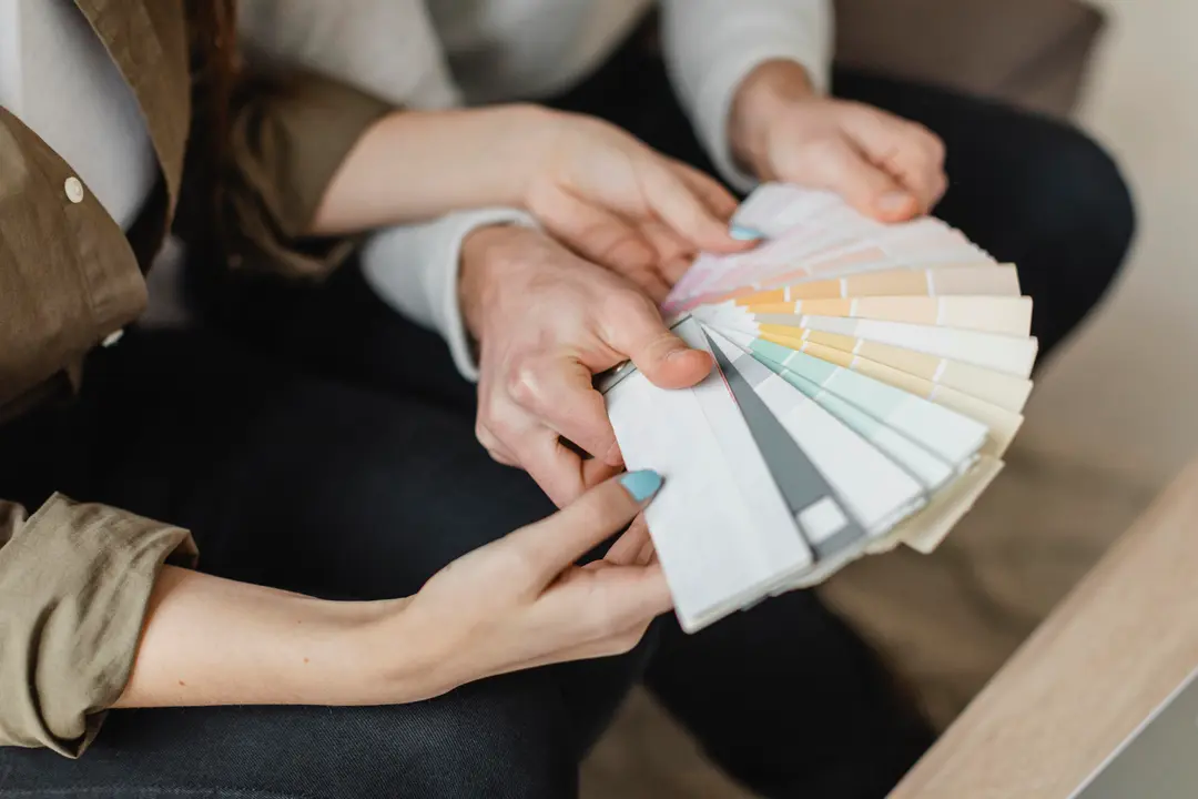 high-angle-couple-making-plans-remodel-home-together-using-paint-palette